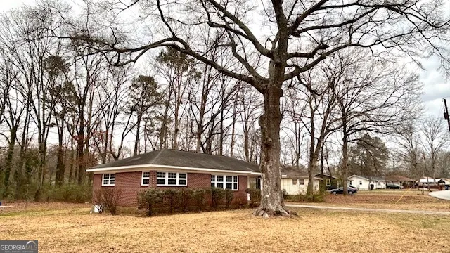 a front view of a building with trees