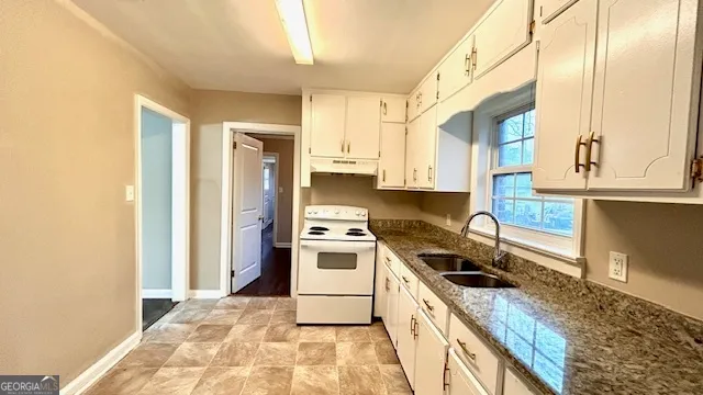 a kitchen with a stove a sink and a refrigerator