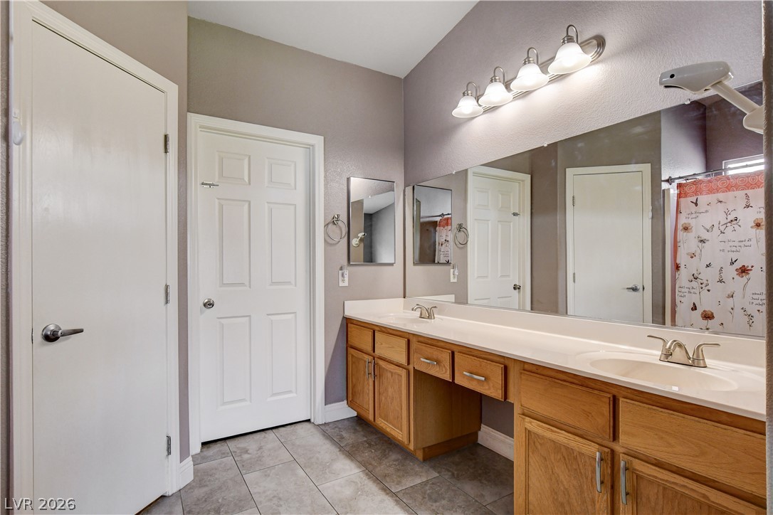 910 Cobblestone Cove Road North Las Vegas, NV 89081 - Photo 14 of 30 A double vanity with ample counter space and storage offers both functionality and classic style.