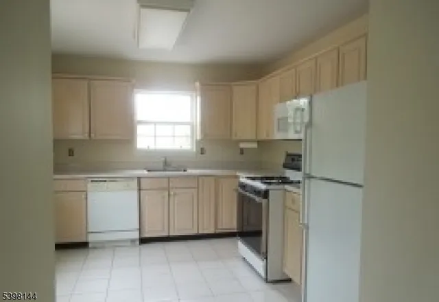 a kitchen with a stove sink and refrigerator