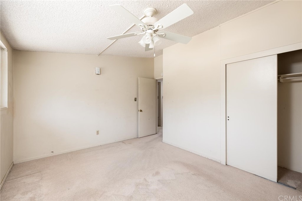 12540 Taunt Place Poway, CA 92064 - Photo 19 of 36 an empty room with a ceiling fan and a window