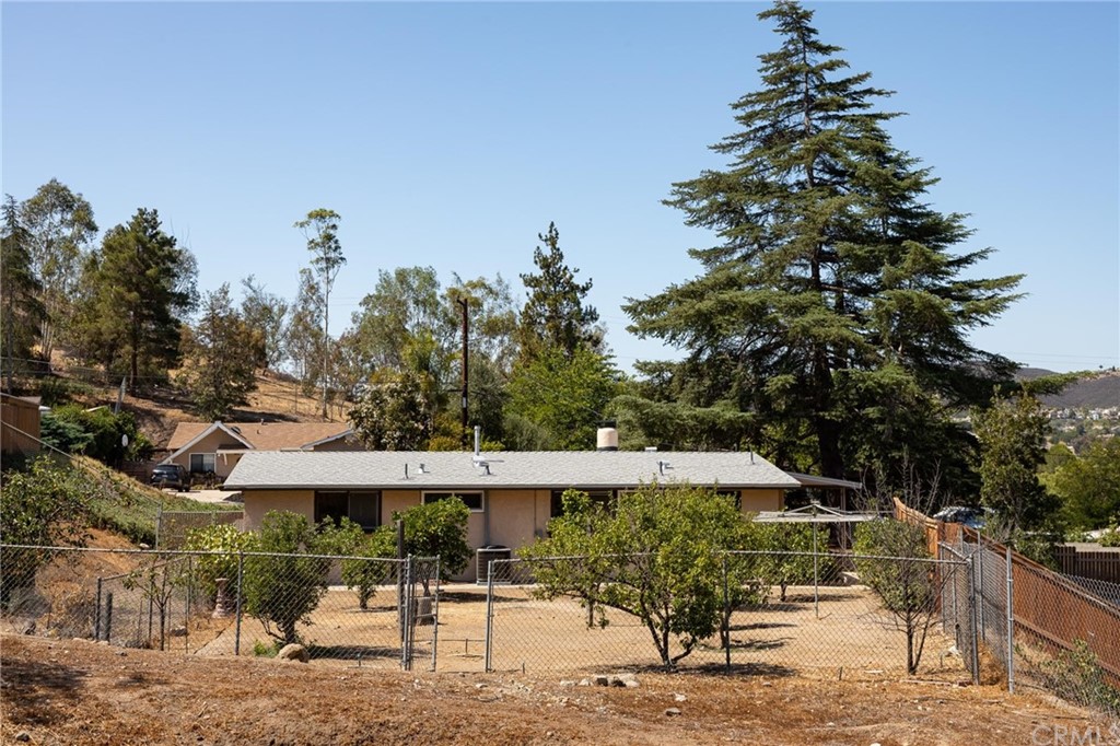 12540 Taunt Place Poway, CA 92064 - Photo 25 of 36 a view of a patio with table and chairs under an umbrella