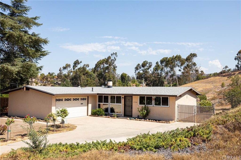 12540 Taunt Place Poway, CA 92064 - Photo 5 of 36 a front view of a house with a yard