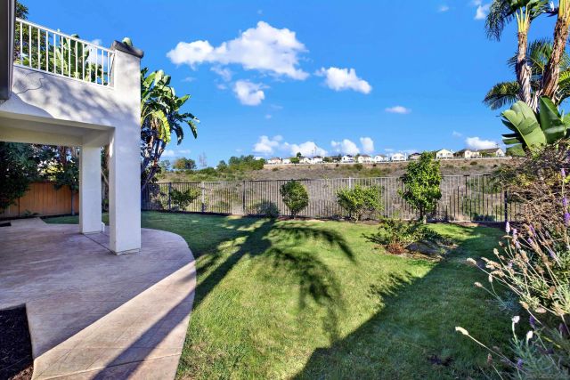an aerial view of a house with a yard and sitting area