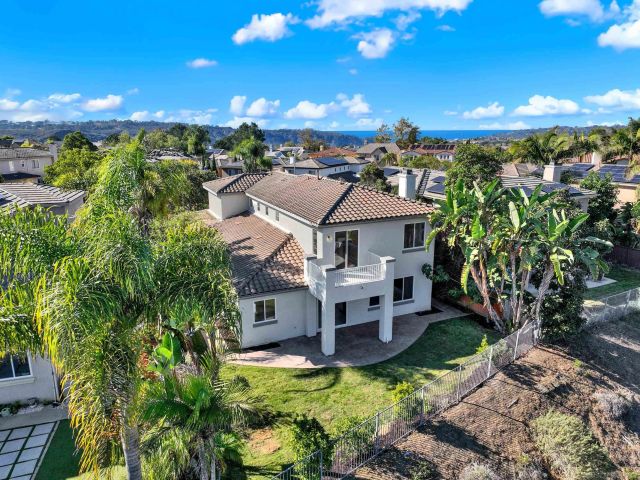a view of a house with a yard patio and sitting area