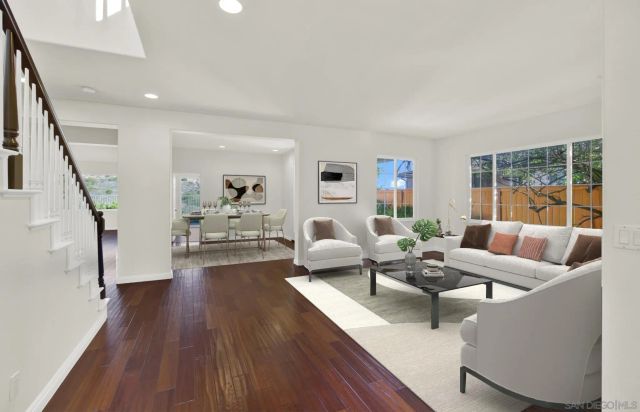 a dining room with wooden floor a chandelier a wooden table and chairs
