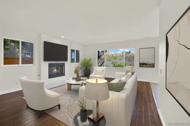 a view of a dining room with furniture a chandelier and wooden floor