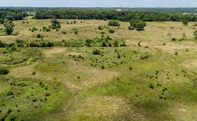 a view of a field with an outdoor space
