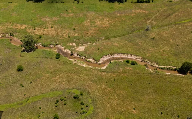 a view of a lake with a yard