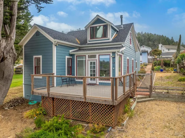 a view of a house with wooden fence