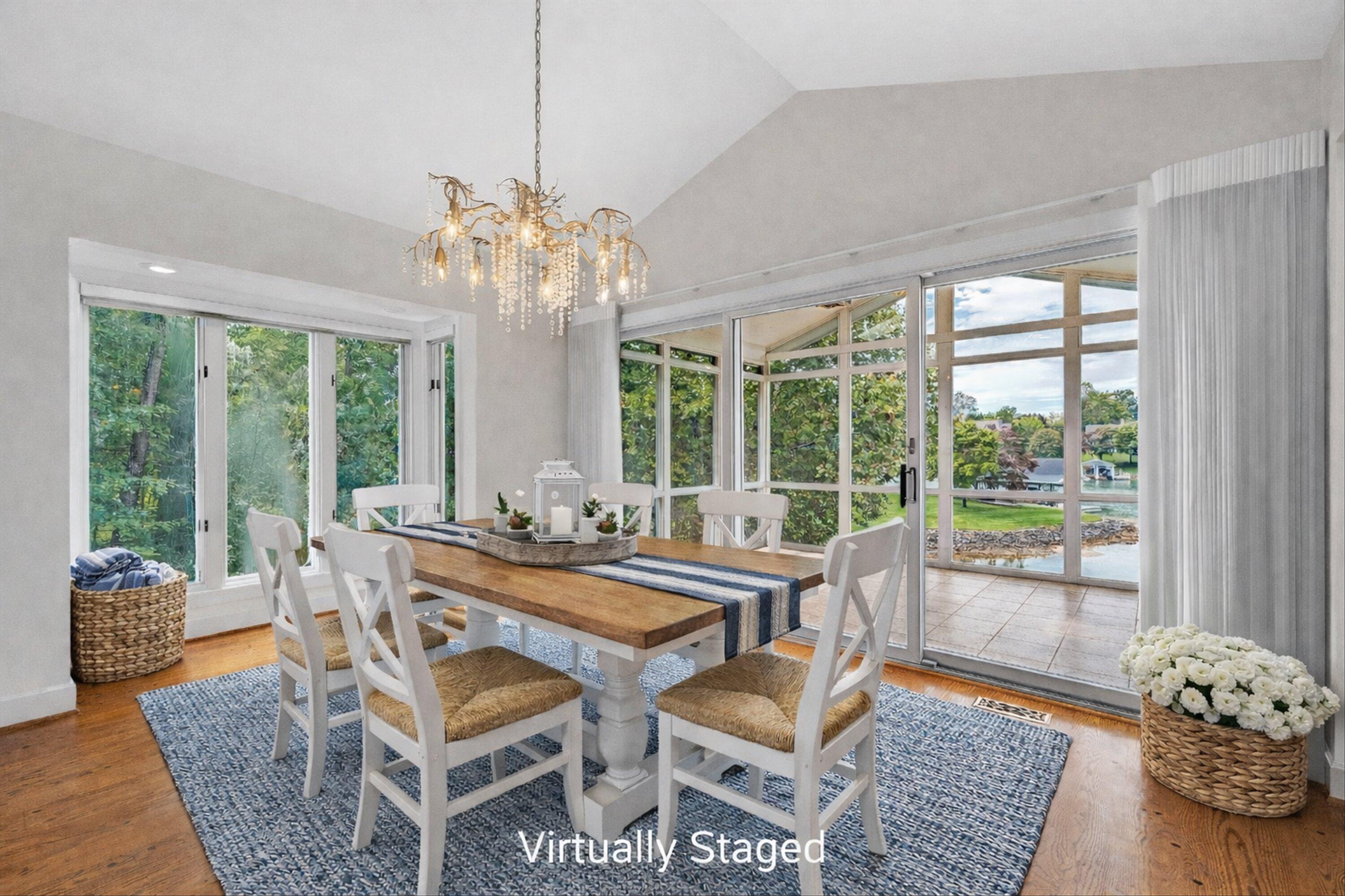 30 Island Green Circle, Unit 22 Penhook, VA 24137 - Photo 15 of 53 a dining room with furniture a chandelier and wooden floor