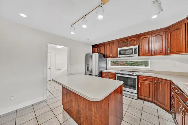 a kitchen with stainless steel appliances a sink stove and cabinets