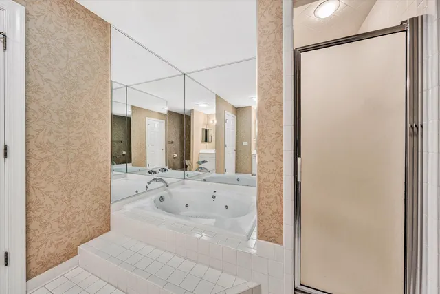a bathroom with a bathtub and a shower