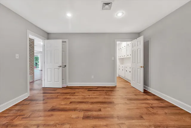 a view of a house with a yard and floor to ceiling window