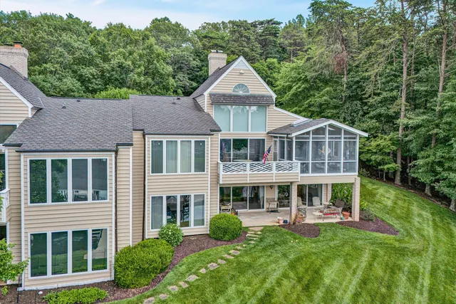 a front view of a house with yard and green space