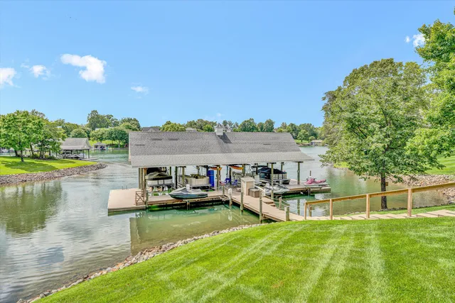 an aerial view of a house with a yard and lake view