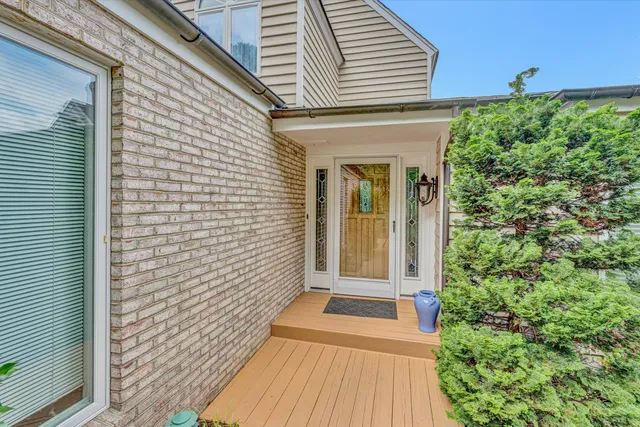 a view of a brick house with a large window