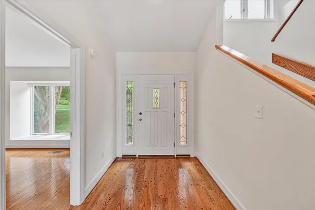 a view of a room with wooden floor and windows