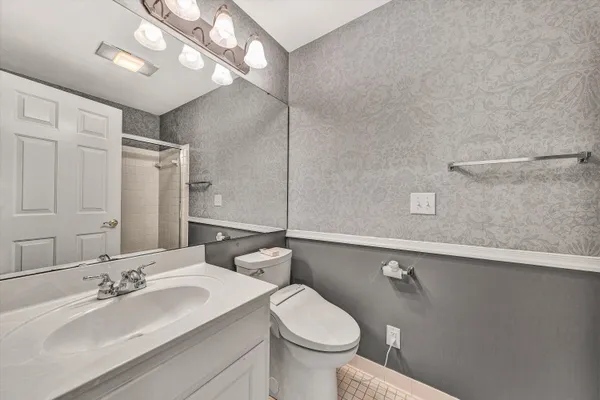 a bathroom with a toilet a sink and a shower