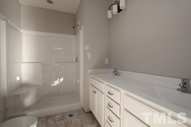 6200 Cotter Ridge Court Raleigh, NC 27603 - Photo 14 of 25 a bathroom with a shower and vanity