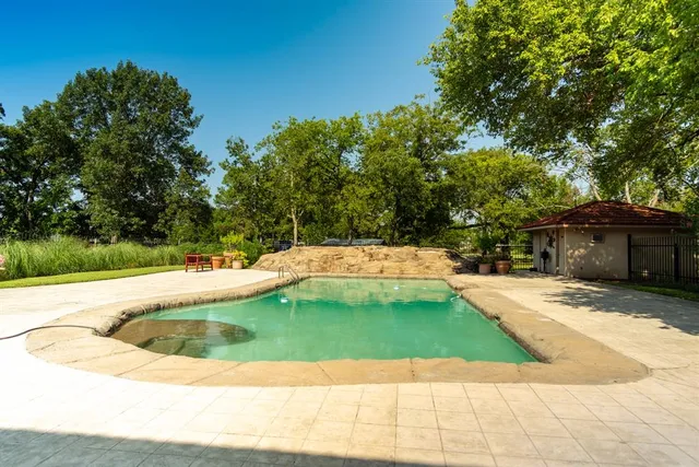 a view of a swimming pool with a patio