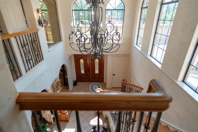 a bedroom with a bed and a chandelier