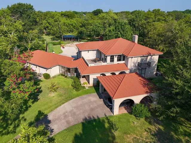 an aerial view of a house with an outdoor space