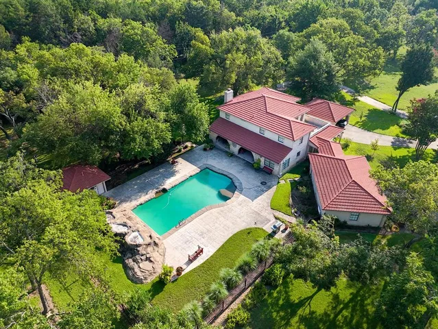 an aerial view of a house with a yard