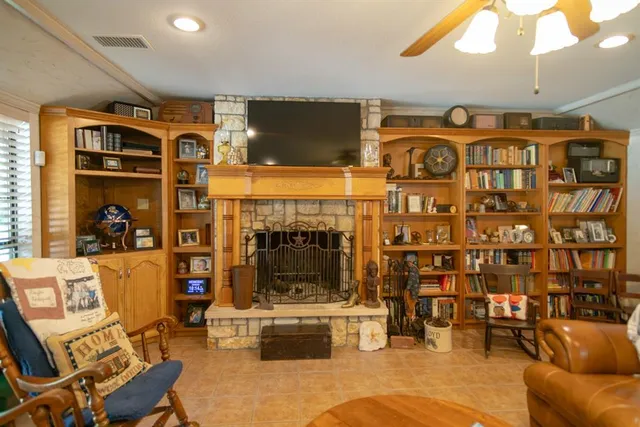 a living room with fireplace furniture and a flat screen tv