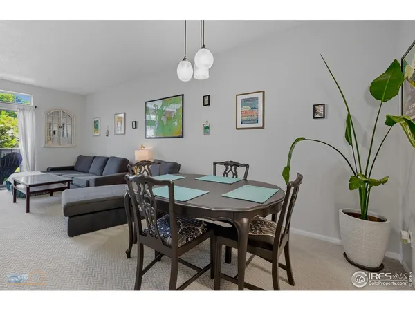 a view of a dining room with furniture and a potted plant