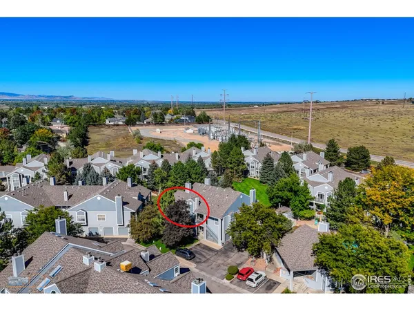 an aerial view of ocean and residential houses with outdoor space