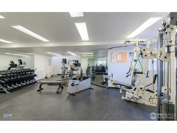 a living room with furniture gym equipment and a window