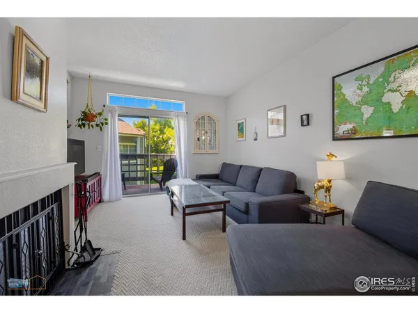 a living room with furniture a flat screen tv and a large window