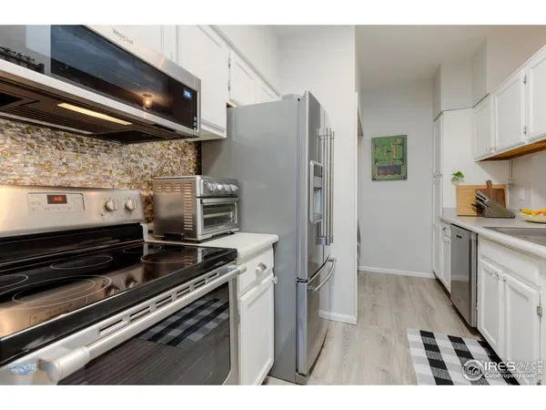 a kitchen with refrigerator and window