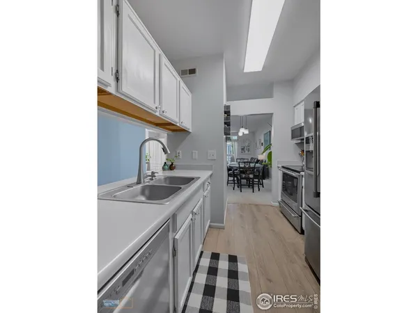 a kitchen with sink and cabinets
