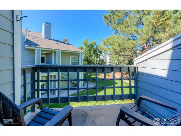 a view of a chairs and table in the backyard