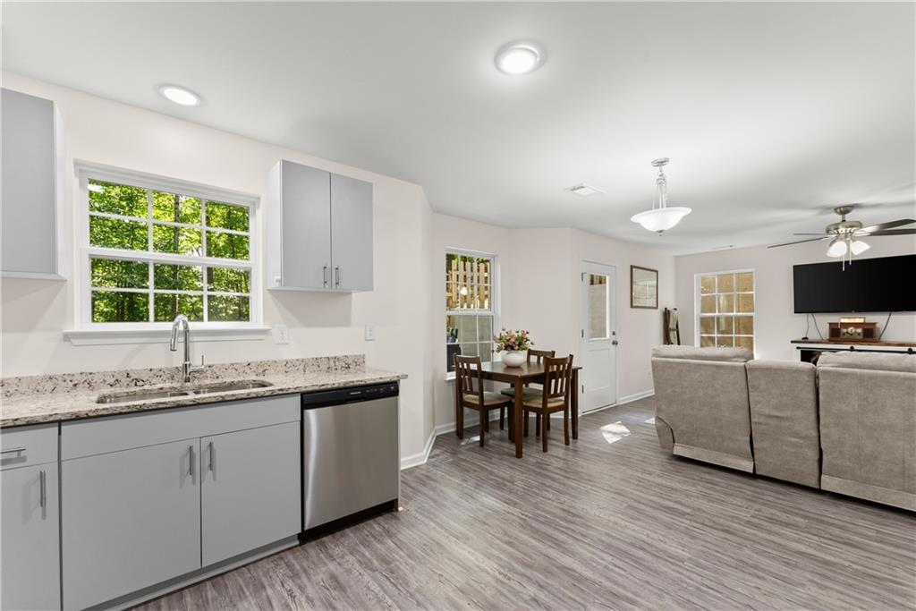 2407 Thompson Mill Road Gainesville, GA 30506 - Photo 16 of 35 a kitchen with granite countertop cabinets stainless steel appliances a sink and a window