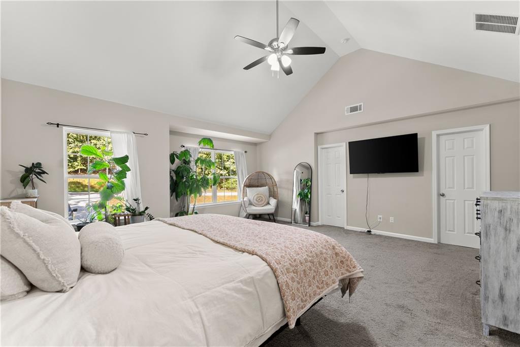 2407 Thompson Mill Road Gainesville, GA 30506 - Photo 20 of 35 a bedroom with a bed a tv and a large window