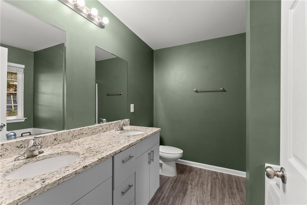 2407 Thompson Mill Road Gainesville, GA 30506 - Photo 21 of 35 a bathroom with a granite countertop sink toilet and shower