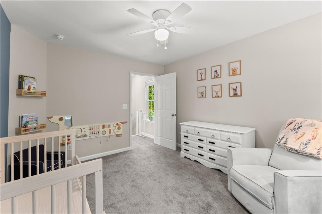 2407 Thompson Mill Road Gainesville, GA 30506 - Photo 25 of 35 a bedroom with furniture and a chandelier fan