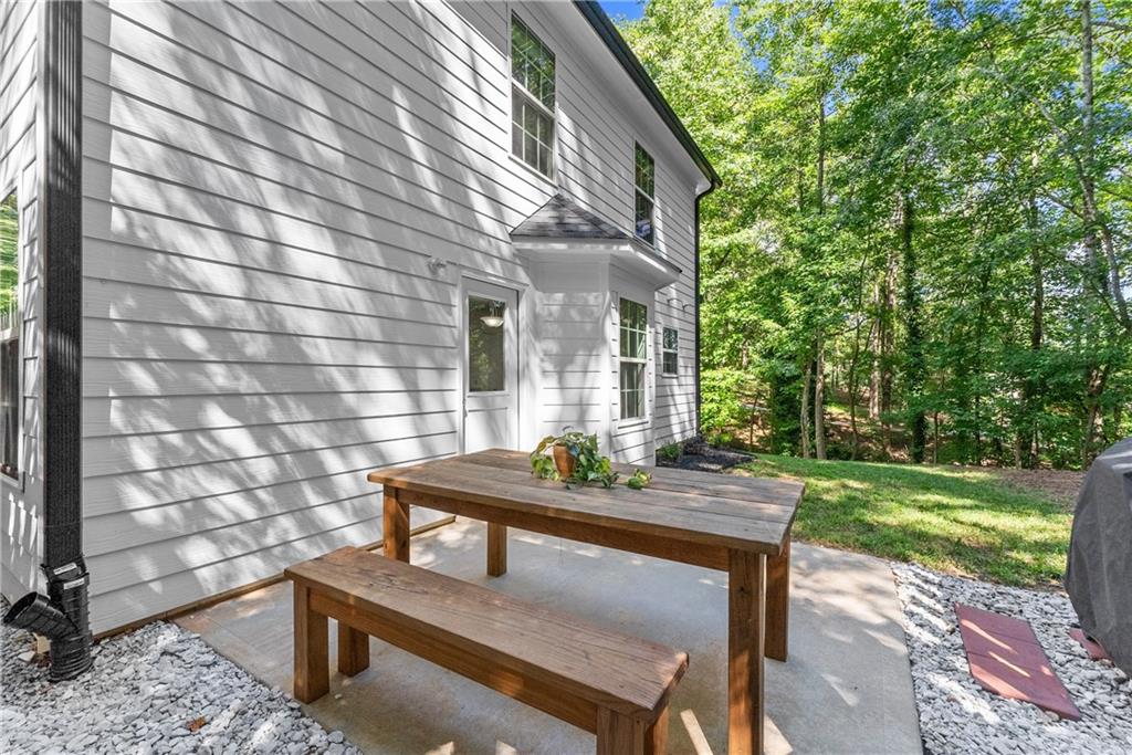 2407 Thompson Mill Road Gainesville, GA 30506 - Photo 30 of 35 a view of a patio with table and chairs and potted plants