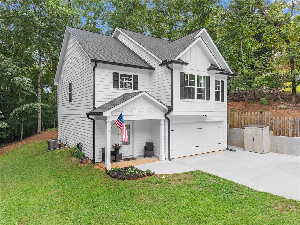 2407 Thompson Mill Road Gainesville, GA 30506 - Photo 4 of 35 a view of a yard in front of a house with plants and large tree