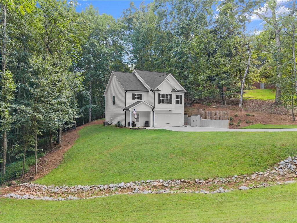 2407 Thompson Mill Road Gainesville, GA 30506 - Photo 6 of 35 a front view of a house with a garden