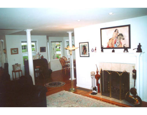 15 Bayview Road Marblehead, MA 01945 - Photo 3 of 6 a living room with furniture a flat screen tv and a fireplace
