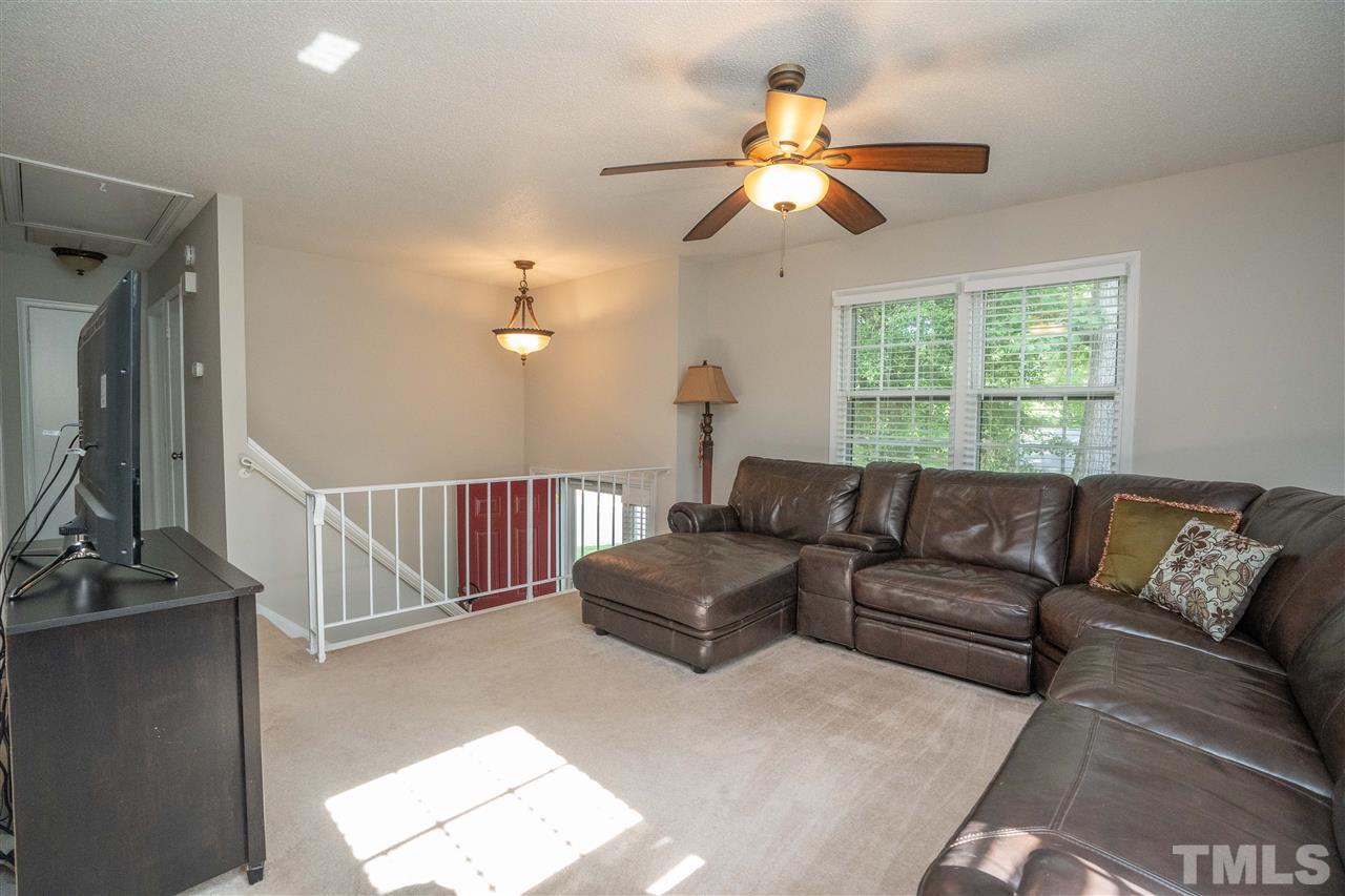 7500 Mine Valley Road Raleigh, NC 27615 - Photo 2 of 25 a living room with furniture a chandelier and a window