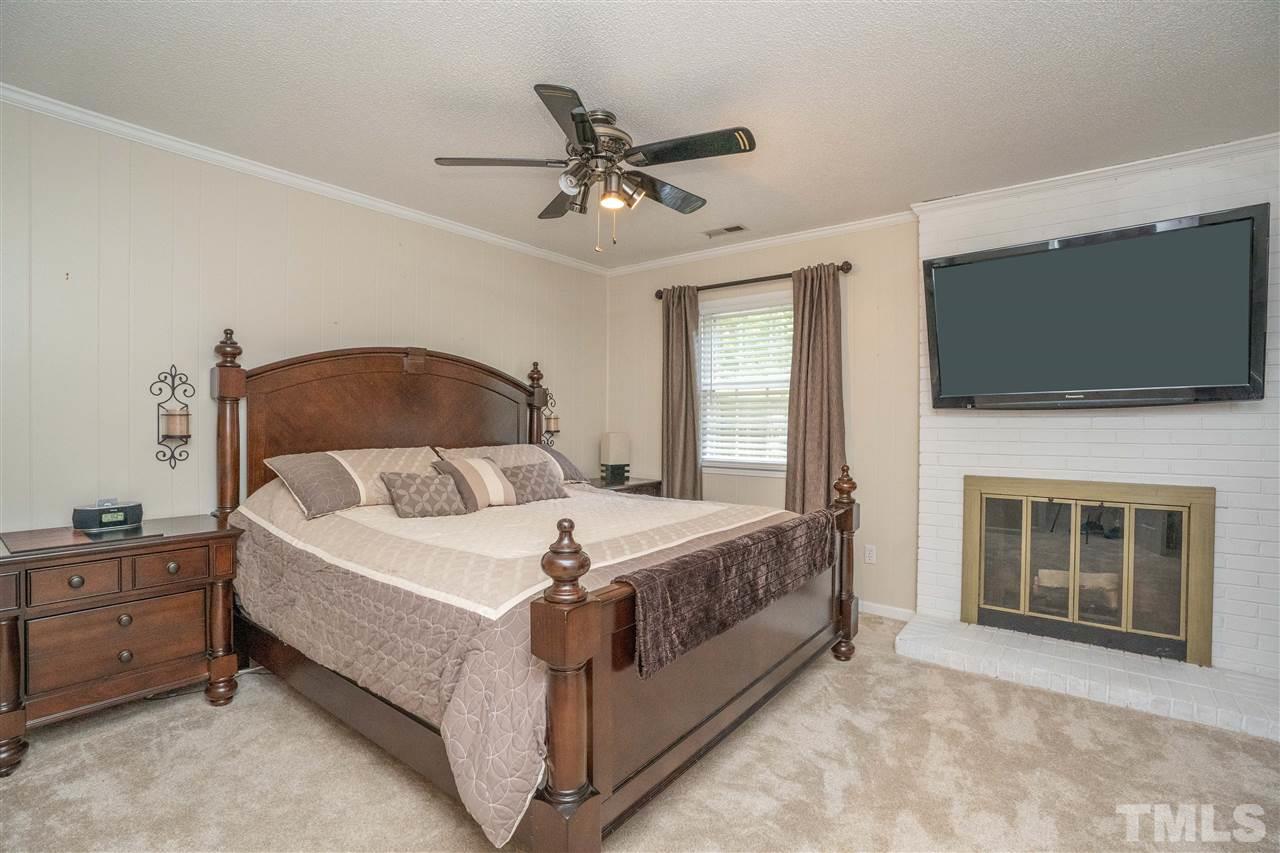 7500 Mine Valley Road Raleigh, NC 27615 - Photo 13 of 25 a bedroom with a bed and a flat screen tv