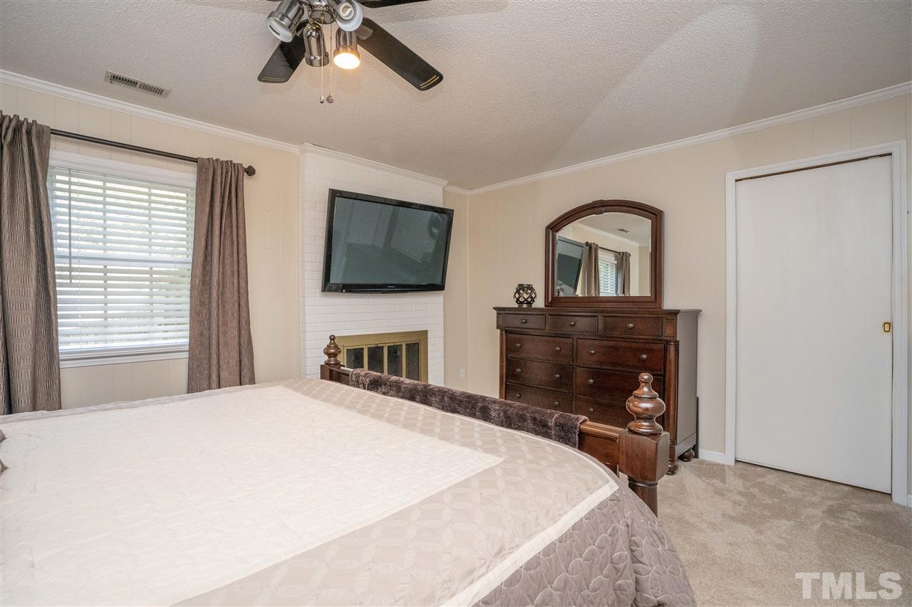 7500 Mine Valley Road Raleigh, NC 27615 - Photo 14 of 25 a bedroom with a bed a flat screen tv and a dresser