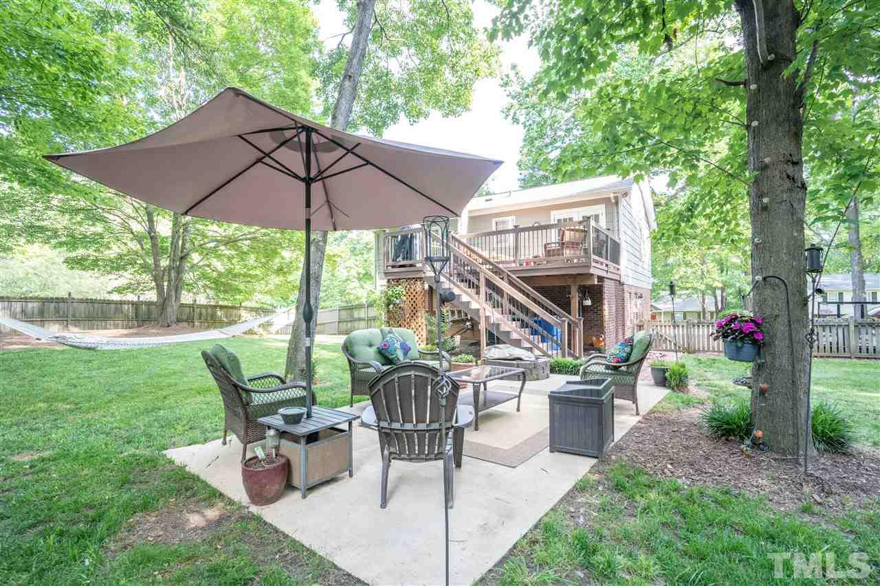 7500 Mine Valley Road Raleigh, NC 27615 - Photo 20 of 25 a view of a patio with table and chairs under an umbrella