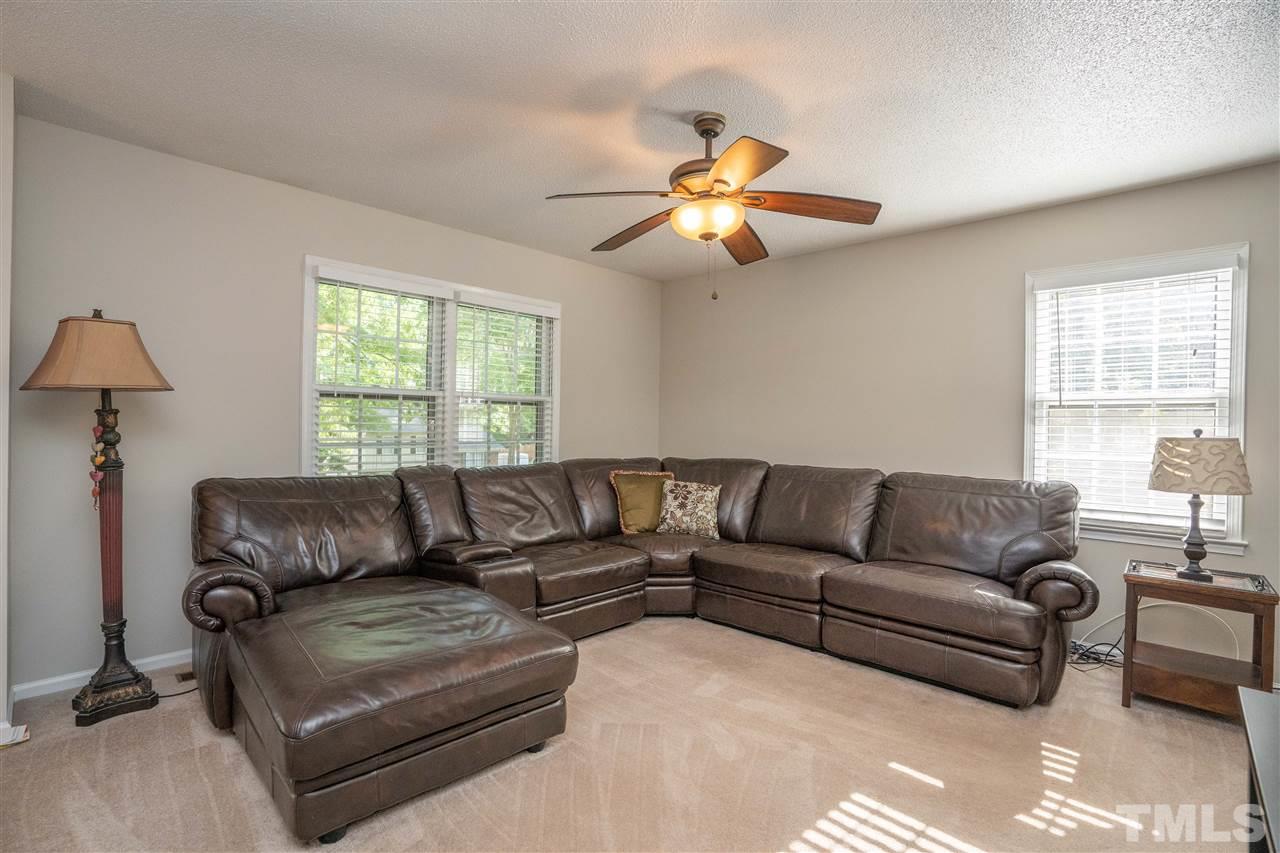 7500 Mine Valley Road Raleigh, NC 27615 - Photo 3 of 25 a living room with furniture a large window and a chandelier
