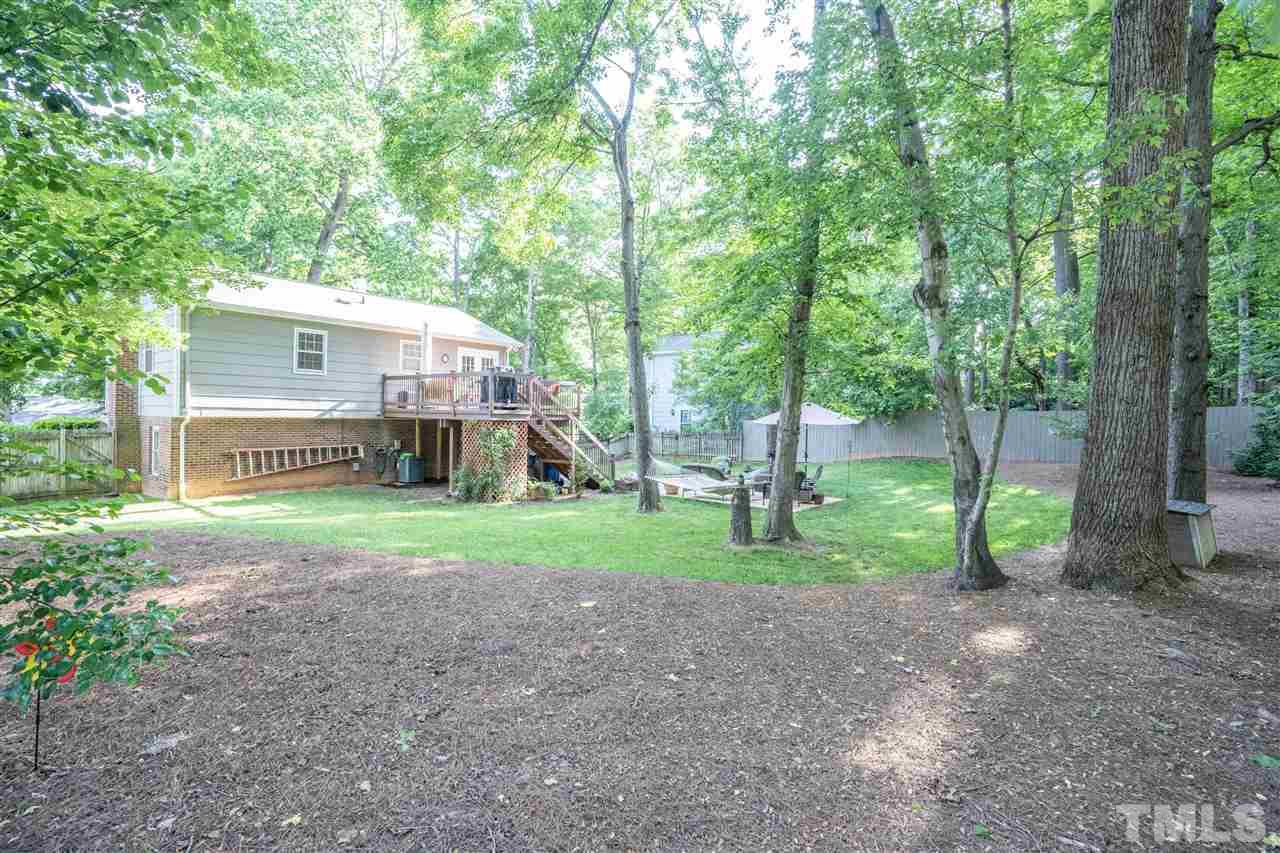 7500 Mine Valley Road Raleigh, NC 27615 - Photo 22 of 25 a view of a house with backyard and trees